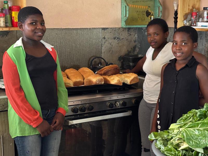 Lentsaba children in kitchen baking bread